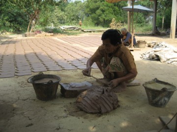 Fixing the clay on the mould and use of wooden cutter